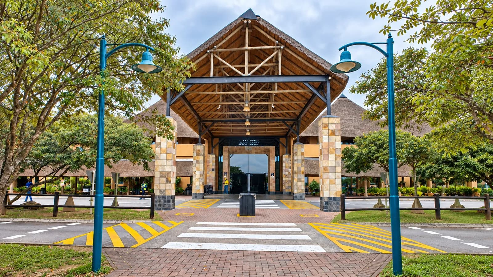 The thatched entrance and pedestrian crossing at KMIA Airport